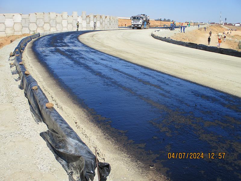A freshly surfaced ramp curve at the Mbudzi Interchange